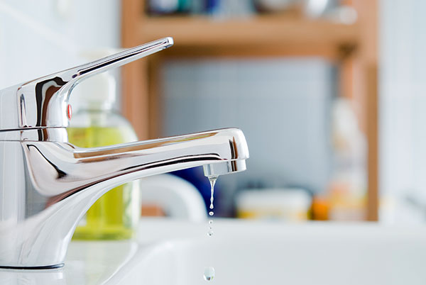 A bathroom tap with drip