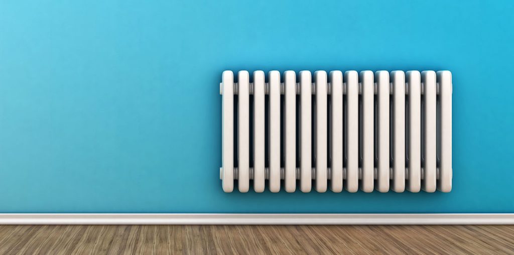 White radiator on a blue wall
